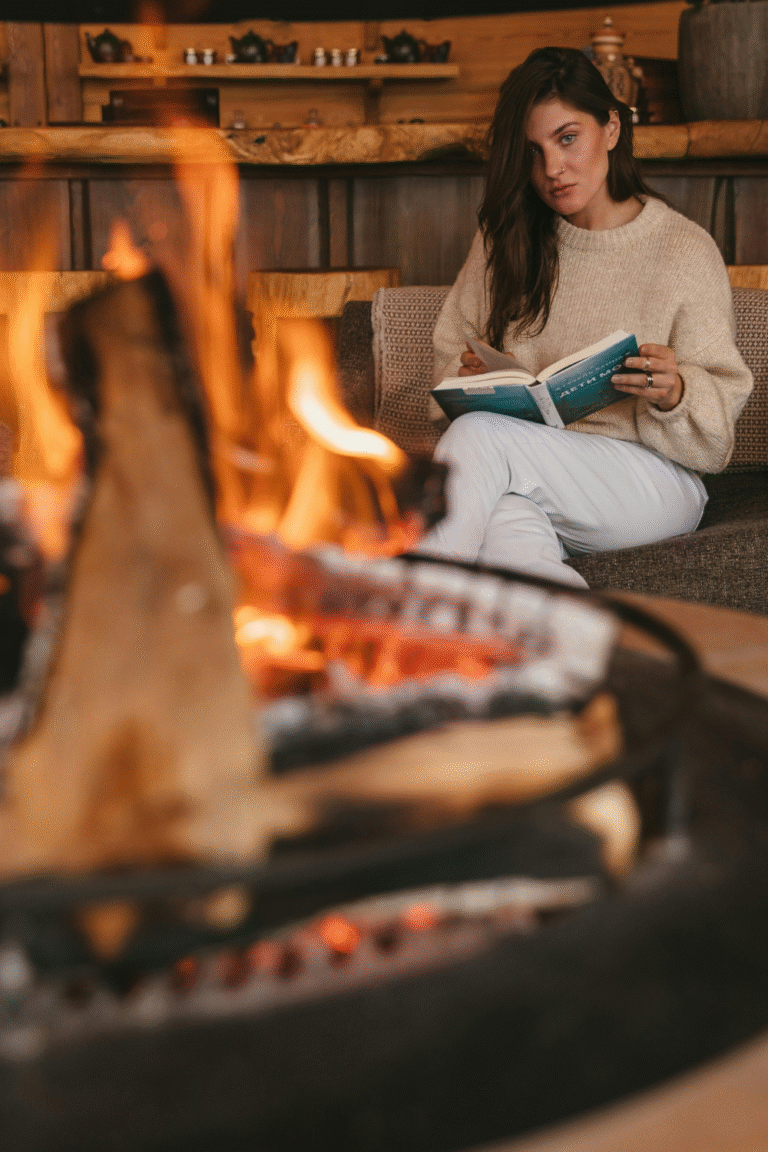 Woman relaxing at a cozy retreat, symbolizing rest, renewal, and the power of taking a weekend away to reset energy and clarity